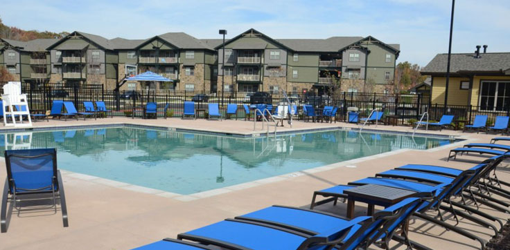 Resort style pool surrounded by lounge chairs